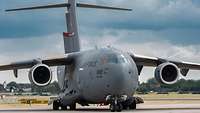 A C17 transport aircraft stands on a taxiway.