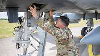 Ein Soldat kniet am Bugfahrwerk einer A-10 Thunderbolt II