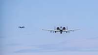 Two A-10 aircraft flying in the sky.