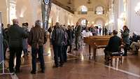 Eine große Personengruppe wartete auf den Beginn der Führung durch das Rathaus.