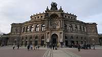 Mehrere Personen befinden sich vor dem Eingang der Semperoper Dresden.