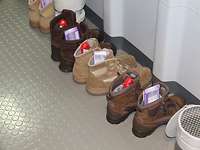 Auf den Gängen aufgereihte Stiefel, welche mit Schokoladennikoläusen und Schokoladentafeln gefüllt sind.