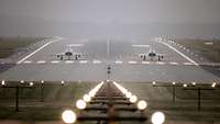 Ready for take off: Two Eurofighters on the runway in Laage in autumn fog