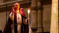 Bischof Rudolf Voderholzer mit einer Kerze in der Hand
