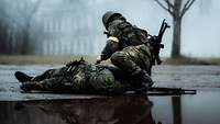 A soldier kneels next to another soldier lying on the ground