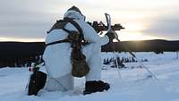 Ein Kommandosoldat auf Skiern geht mit seinem Gewehr G95k in Anschlag