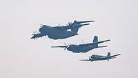Three generations of transport aircraft together in the air.
