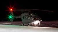 H145M on the ground in a snowy landscape at night.