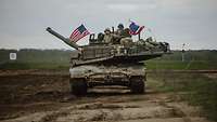 US-amerikanische Soldaten fahren in einem Abrams-Kampfpanzer im Gelände