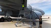 Two people refueling the A330 MRTT Aircraft.