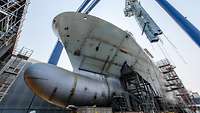 A ship's hull during construction in a dry dock