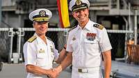 Two naval officers in white uniforms.