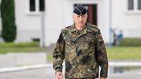Portrait: A man in a camouflage uniform.