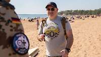 A man is interviewed on the beach