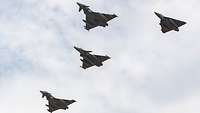 Four fighter jets fly in formation over the air base in Sulur