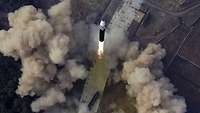 A large rocket takes off from a launch site.