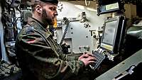 A soldier operates the new digital command-and-control system in the Leopard 2 main battle tank.