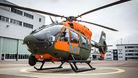 A helicopter parked on the apron in front of the Airbus plant buildings in Donauwörth.