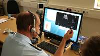 Ein Mann Bertrachtet ein Ultraschallbild auf einem Monitor