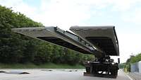 Armored bridgelaying vehicle with extended bridge